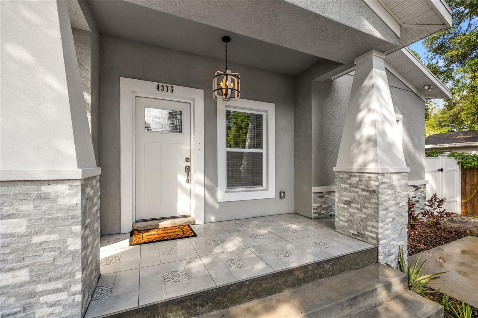 Craftsman styled oversized front-porch with in-lay tile