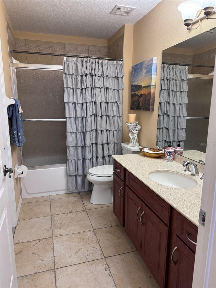 Remodeled bathroom -  new shower glass door, new wooden cabinet doors and pull, new sink with faucet, new Kohler water saver commode