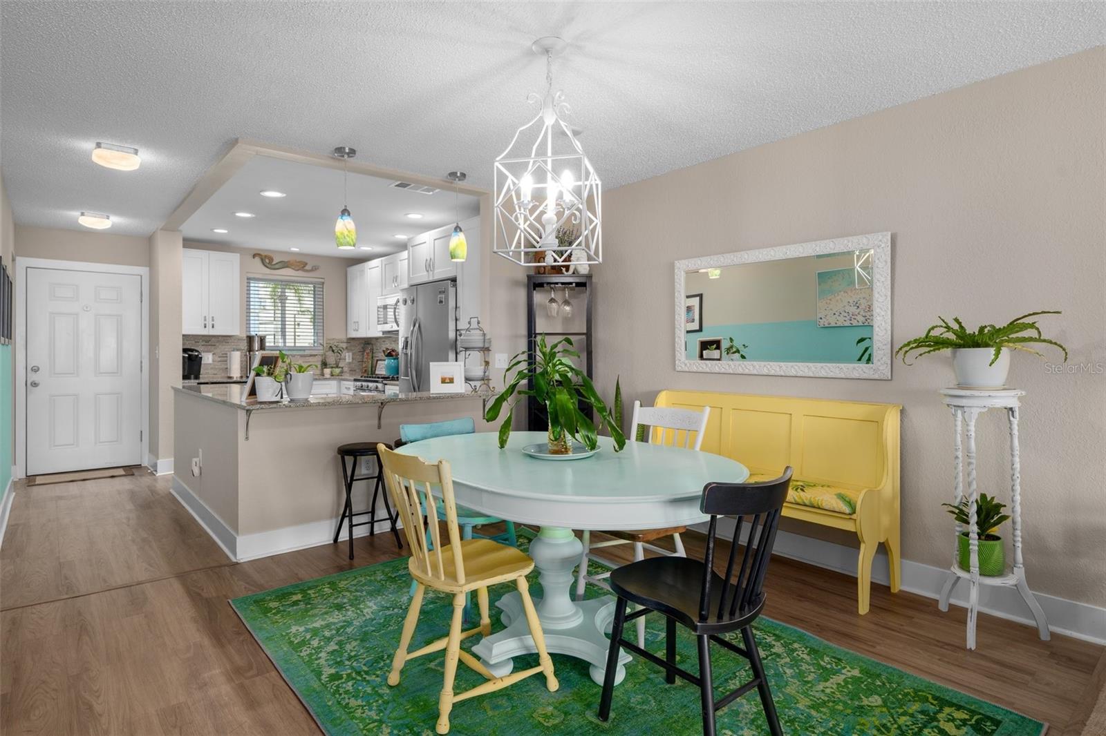 The dining room allows plenty of space for entertaining and furniture.  The extended edge of the countertop, offers the perfect place for a few stools to use as a casual spot to hang out as well.