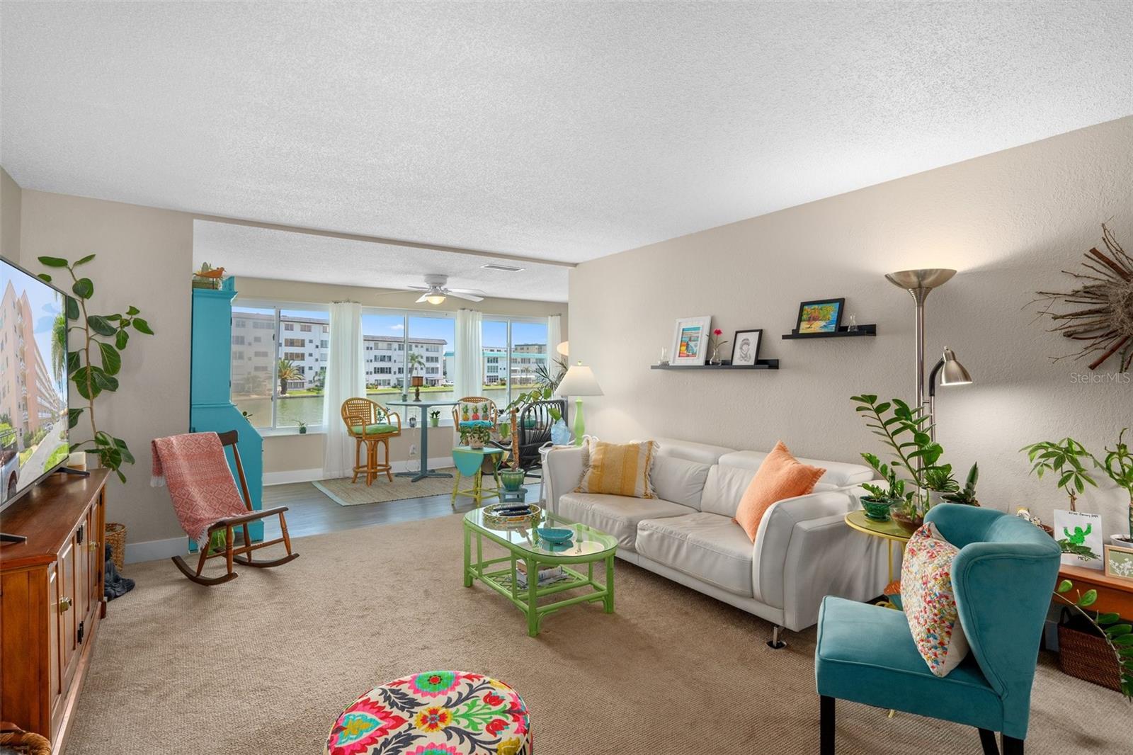 Another angle of the living room, showing off the beautiful hurricane rated windows overlooking the water!