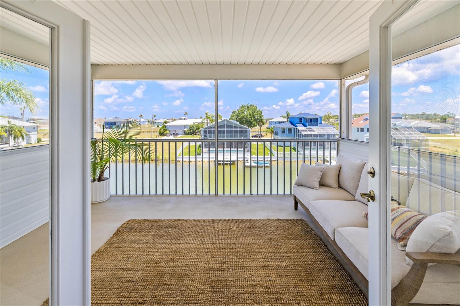 French doors leading to screen balcony with views.