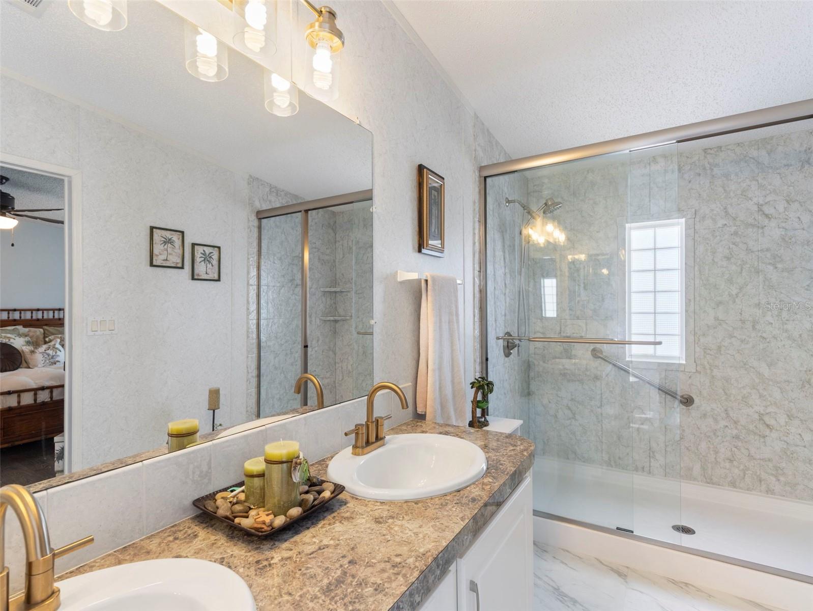 Bath ensuite with Stunning shower with grab bar, upgraded faucets and sleek floors
