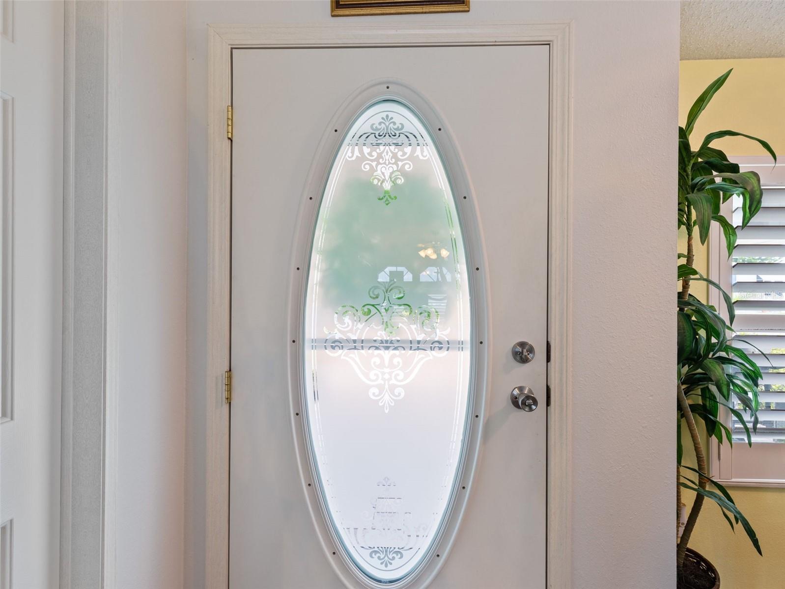 Oval glass door adds more light to the foyer