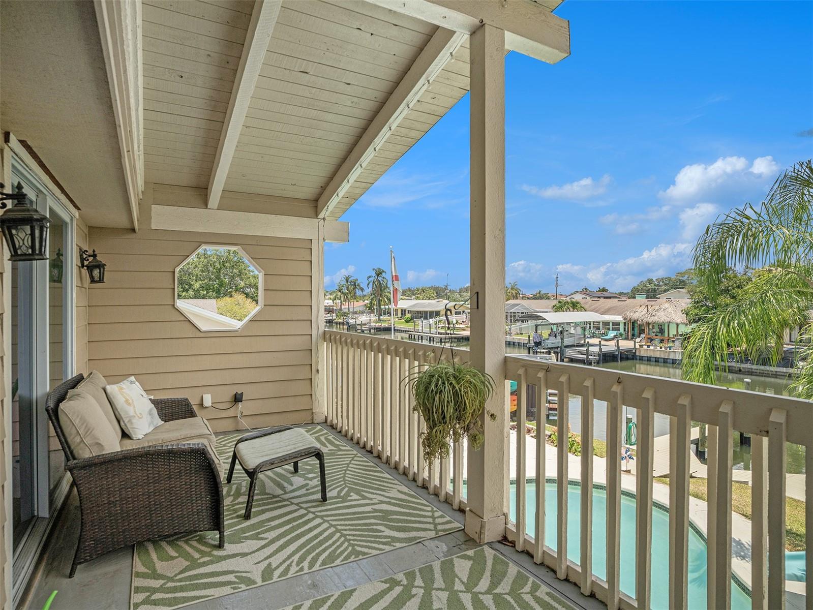 Private balcony overlooking the pool and canal.