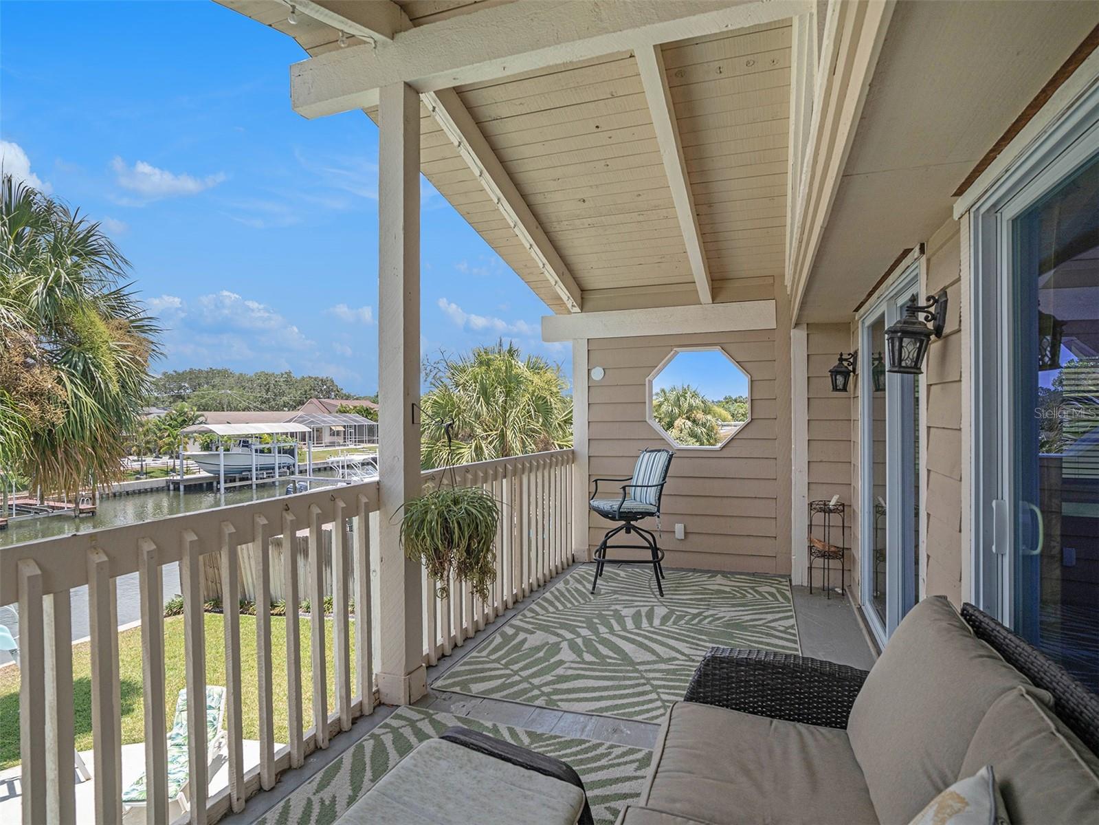 Private balcony overlooking the pool and canal.