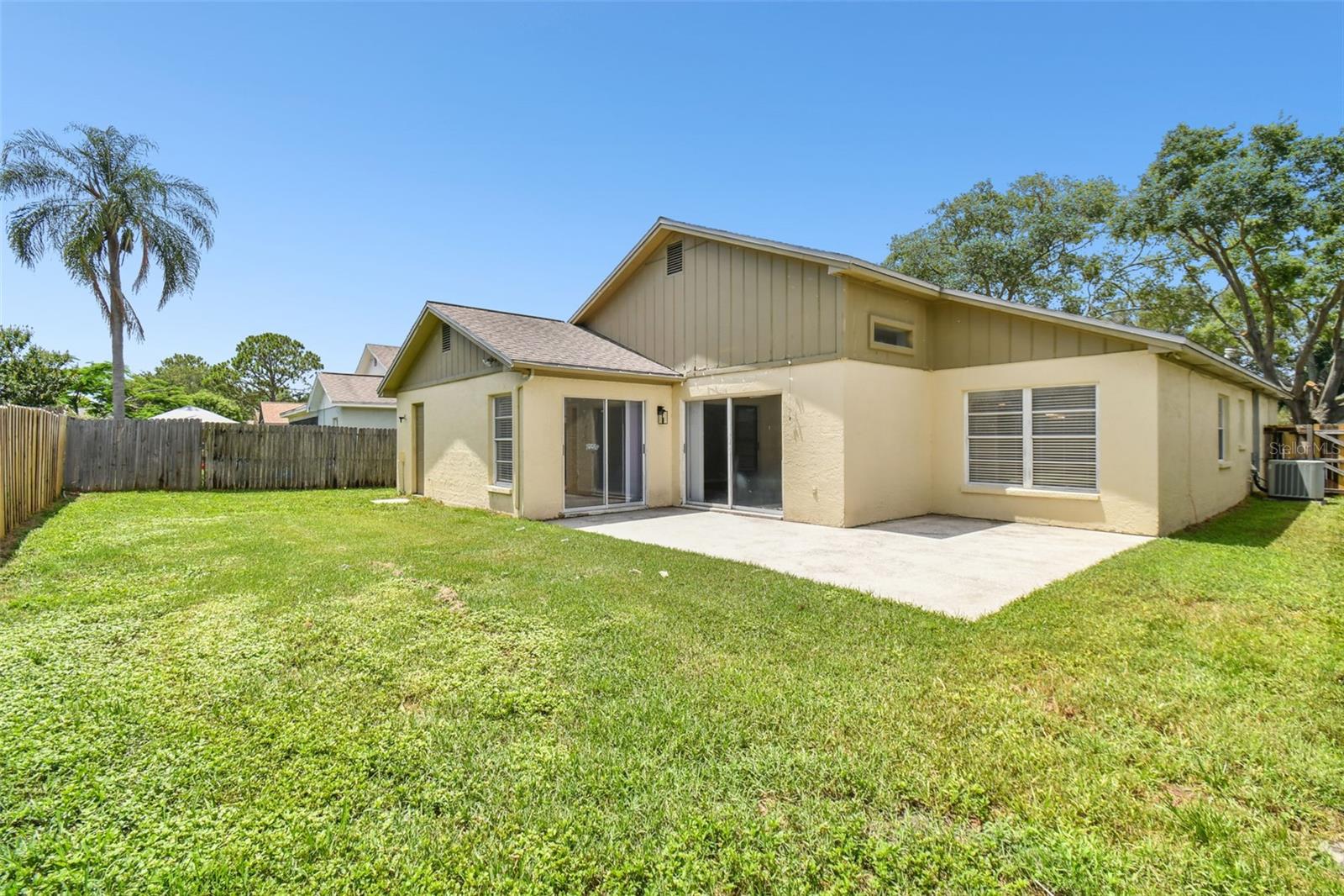 Spacious fenced in back yard with patio for entertaining