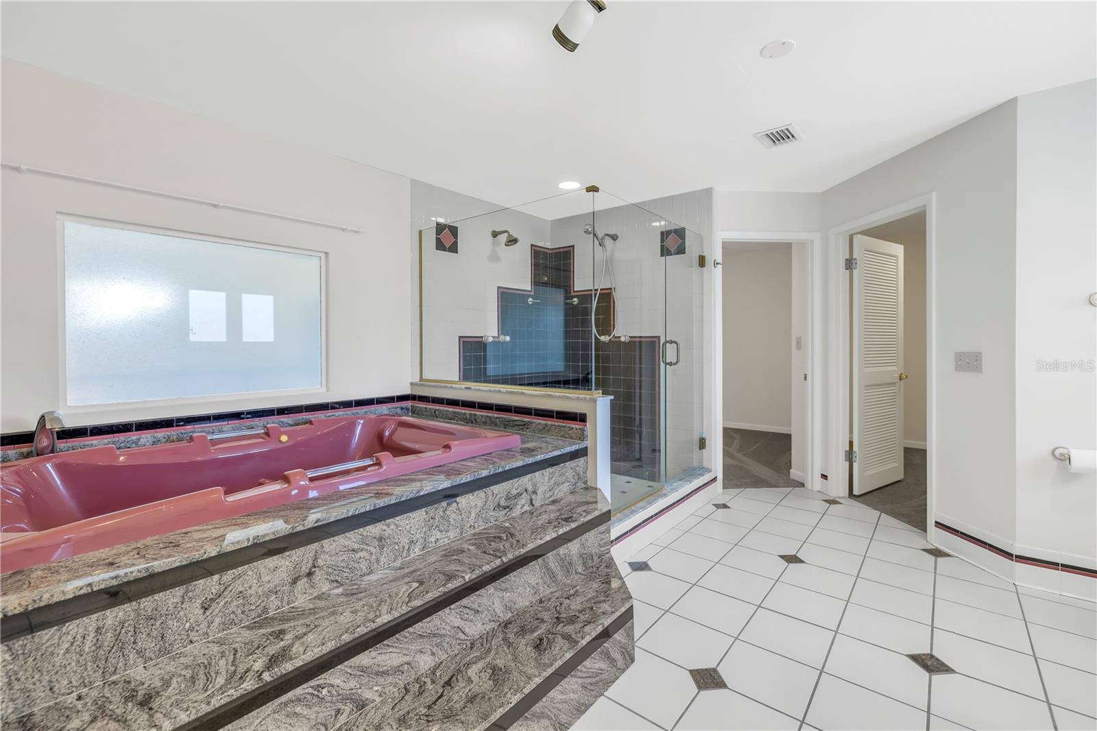 Deep spa tub and large shower - 2 huge walk-in closets just beyond the bath