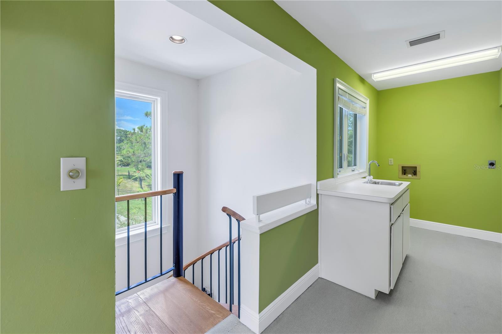 Spiral staircase from main suite storage & laundry room