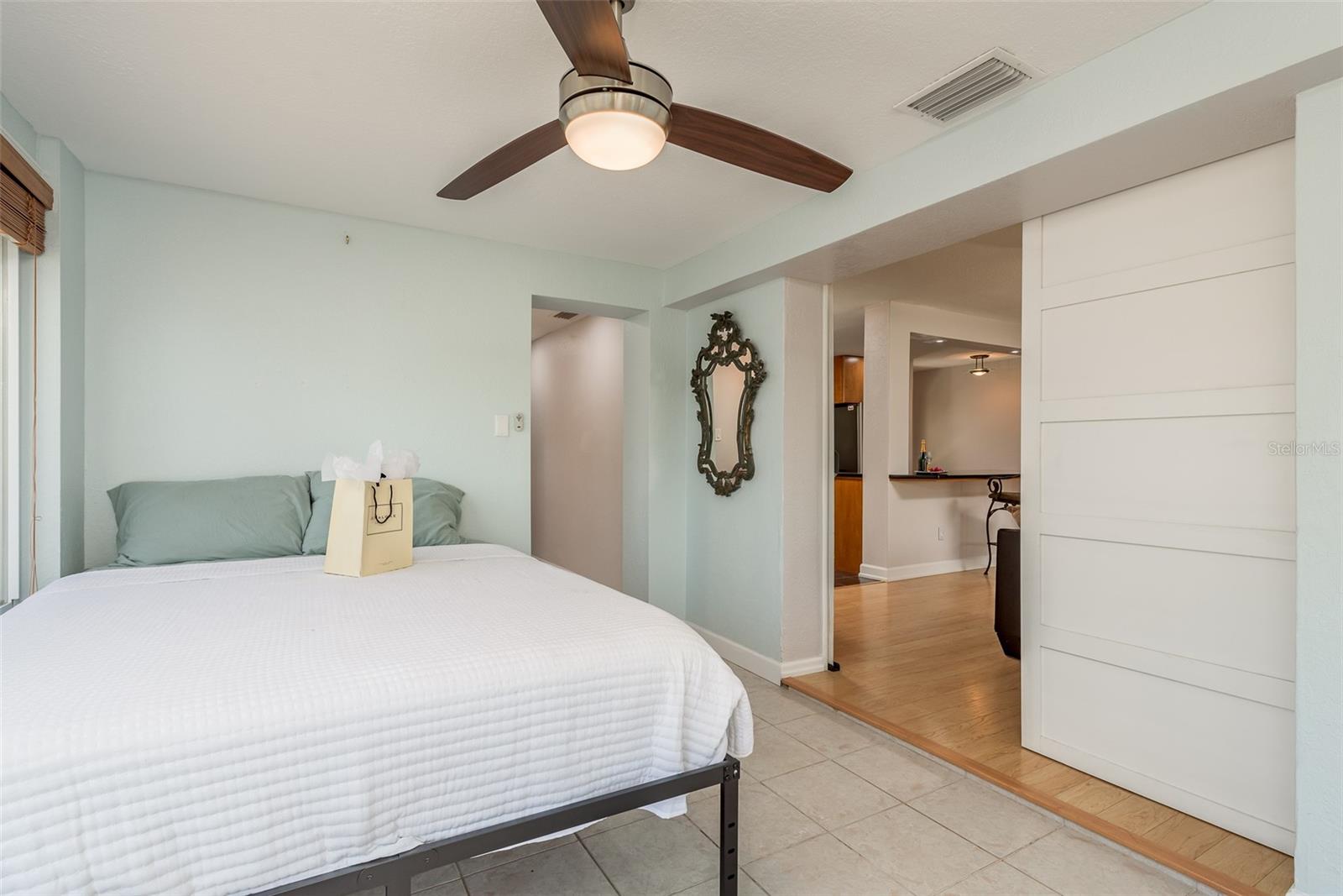 As you enter Bedroom 3 through the gorgeous barn doors, you're immediately greeted by picturesque water views and abundant sunlight, creating a tranquil and inviting atmosphere. Additionally, this room conveniently houses a stackable washer and dryer, combining functionality with charm.