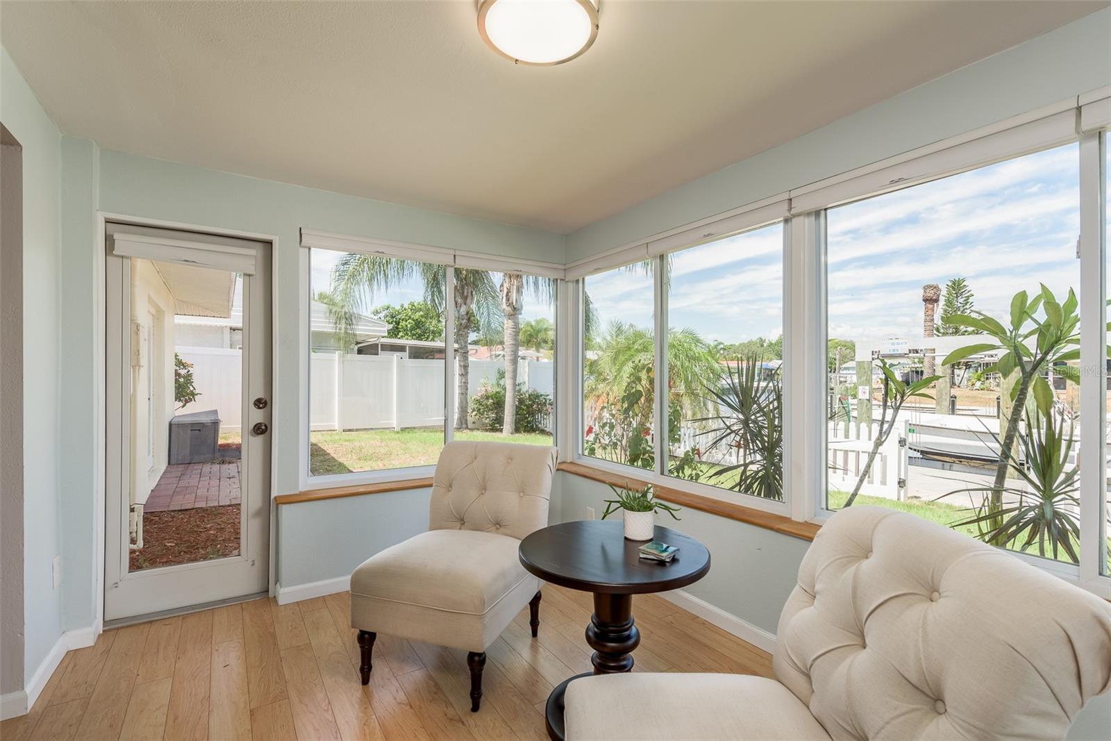 This cozy sitting/dining area also offers convenient access to the backyard and boat dock, allowing for seamless indoor-outdoor living and effortless enjoyment of waterfront activities.