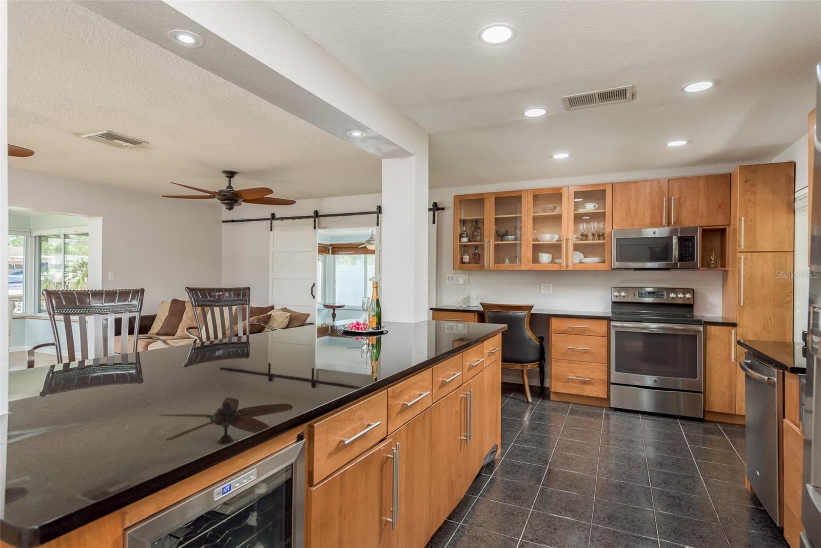 The kitchen is adorned with ceramic tile flooring throughout, enhancing its luxurious and polished ambiance.