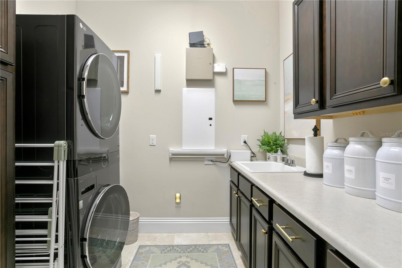 The laundry room with counter space for folding and sink is located on the 2nd floor