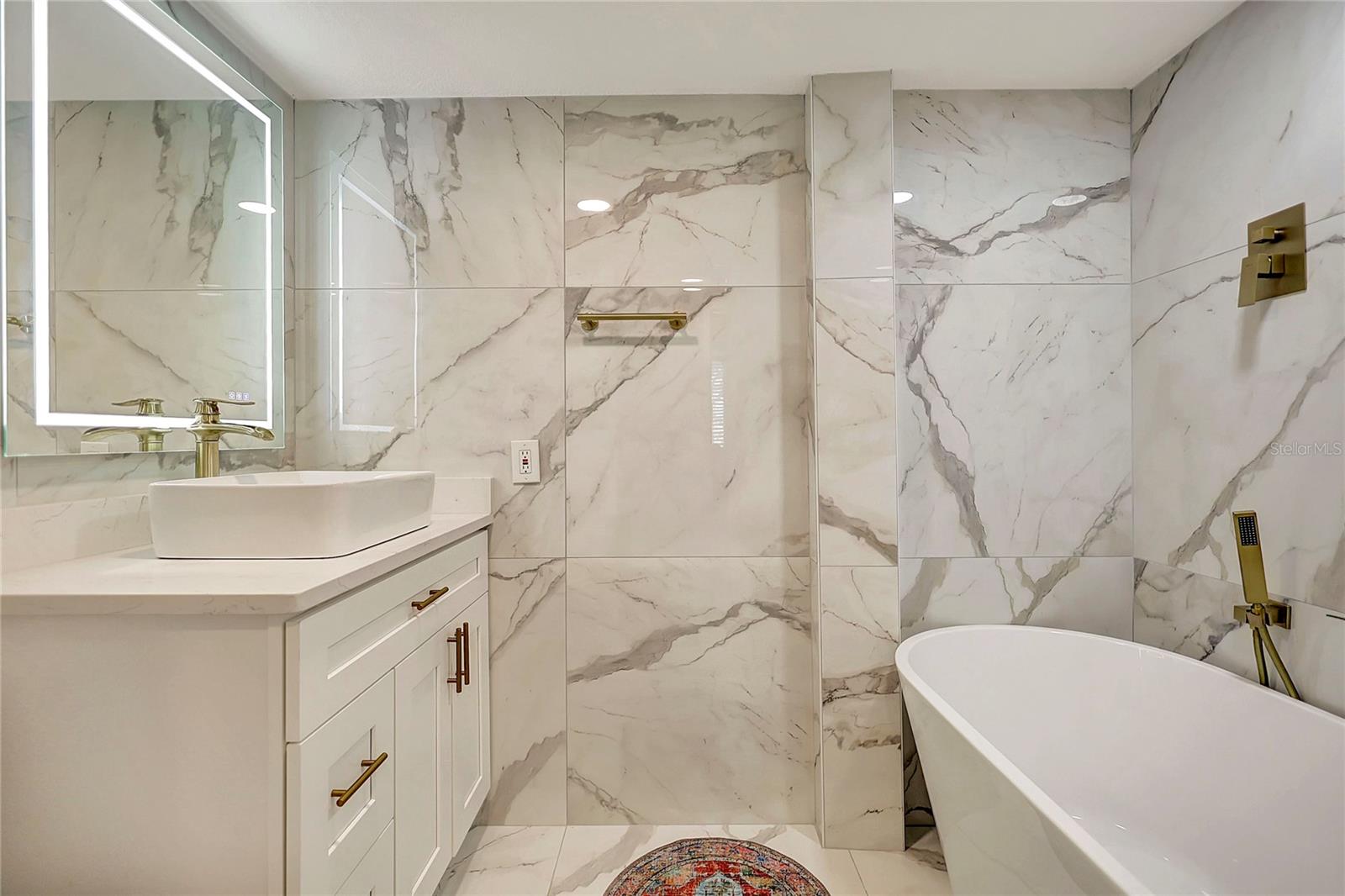 The luxurious ensuite bathroom of this condo's master bedroom, complete with a relaxing bathtub for soaking away the day's stresses.