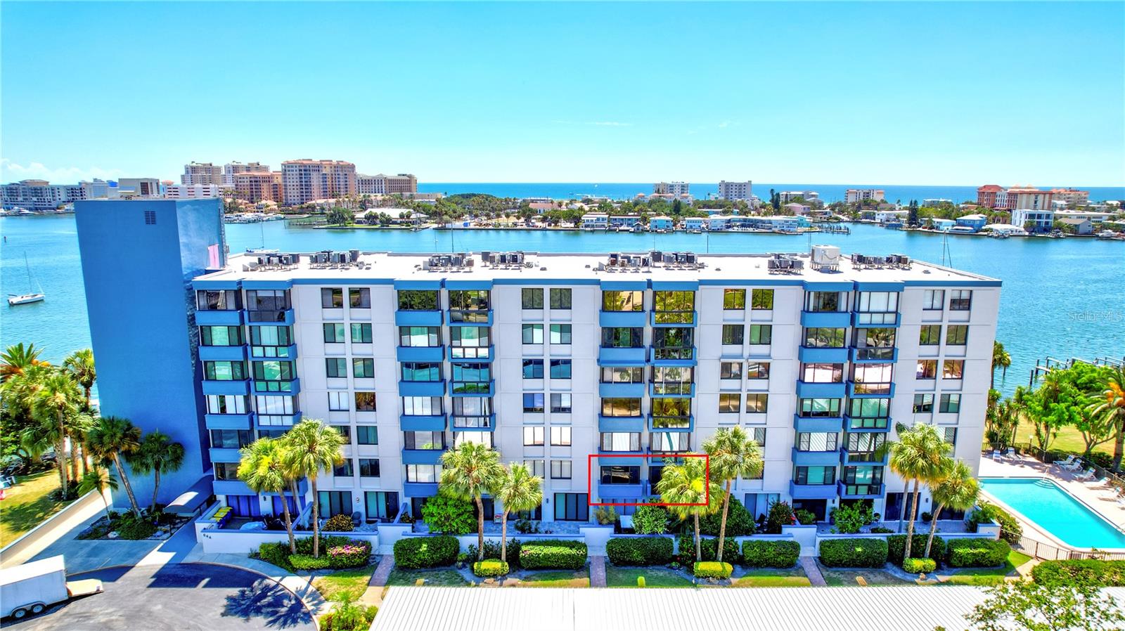 This view shows how well the condo fits into its beautiful waterfront surroundings, offering a serene and scenic place to live.