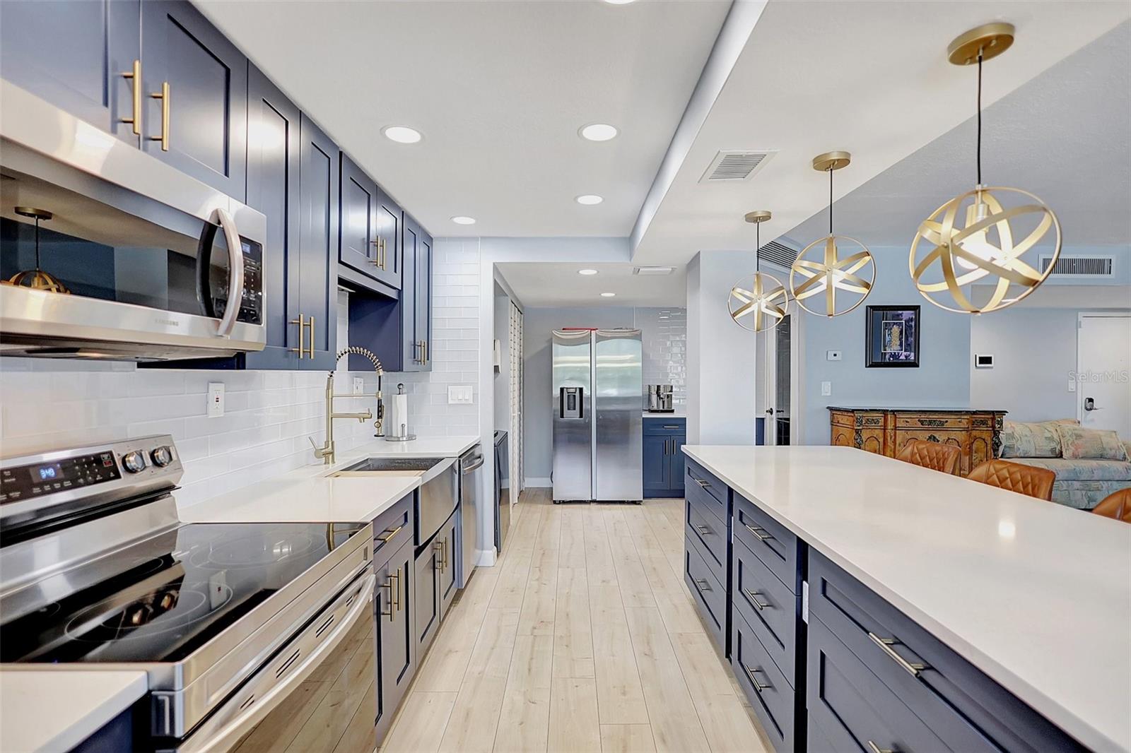 Whether you're cooking meals or enjoying casual dining at the island table, this kitchen is both stylish and functional, making it a central part of your comfortable waterfront living.