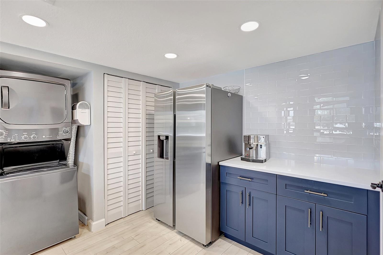 This condo's kitchen is equipped with sleek stainless steel appliances that add a touch of the unit's style.