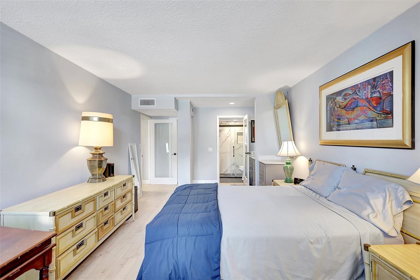 Relax in the comfort of this condo's master bedroom, where you can see a clear view of the entrance to your private ensuite bathroom.