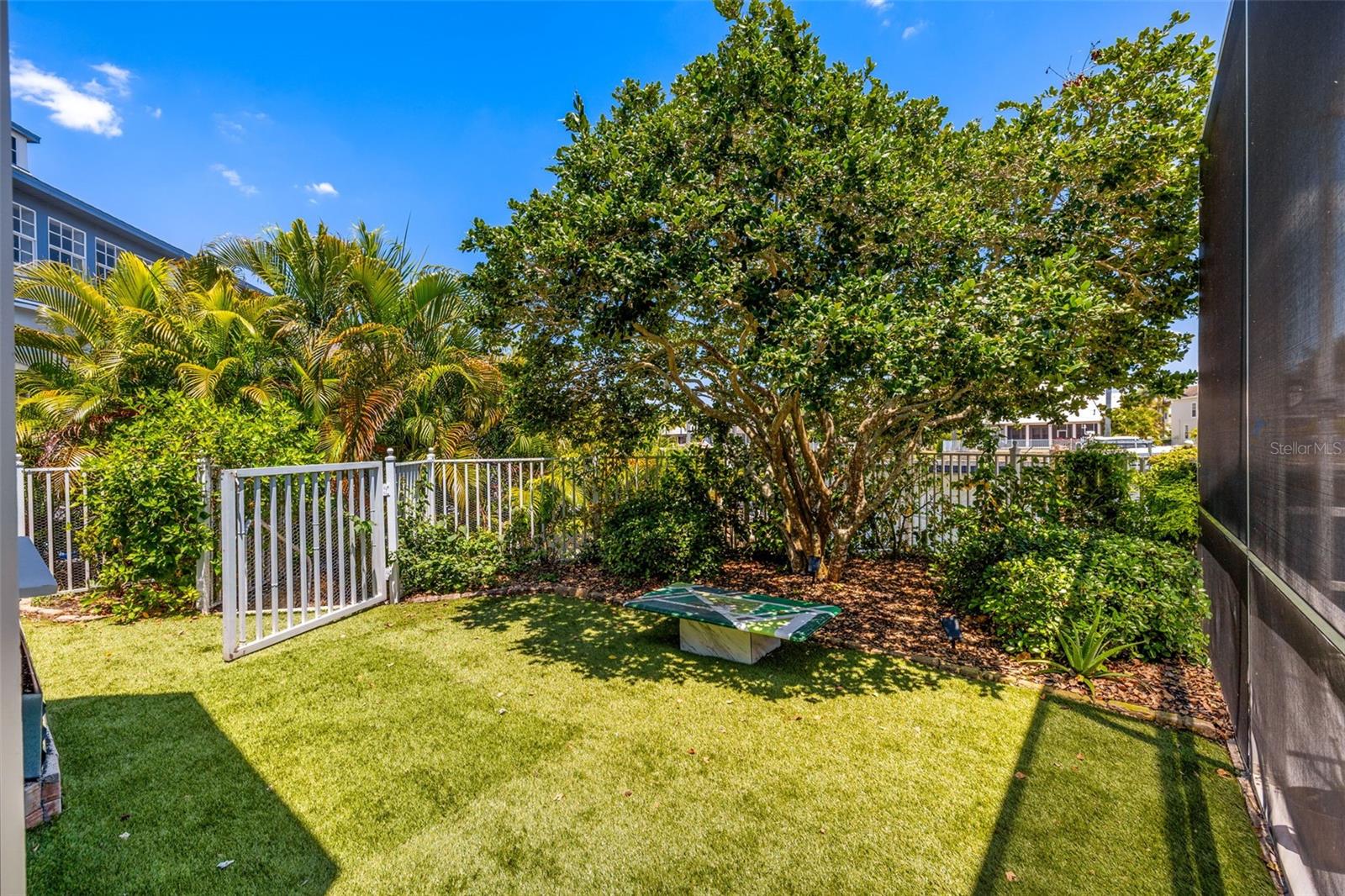 Enclosed yard with turf and planter boxes/garden