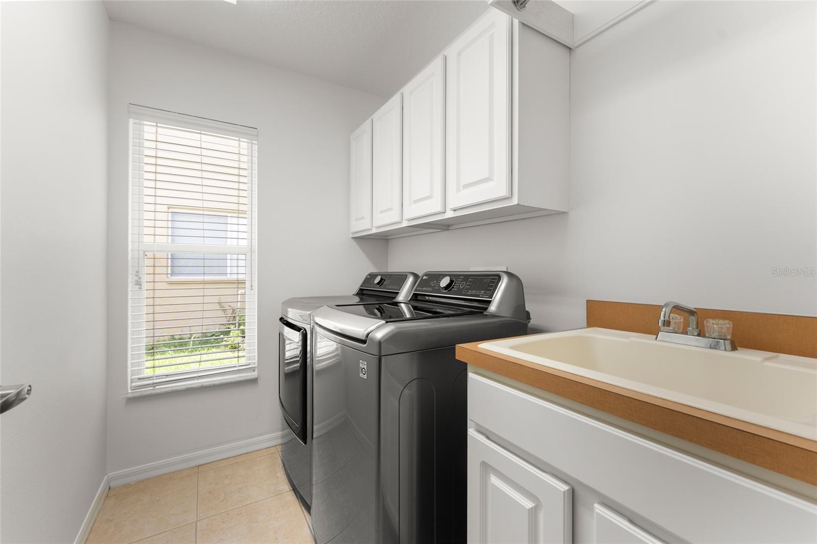 Laundry Room With Cabinets, Hanging Rack and Laundry Sink