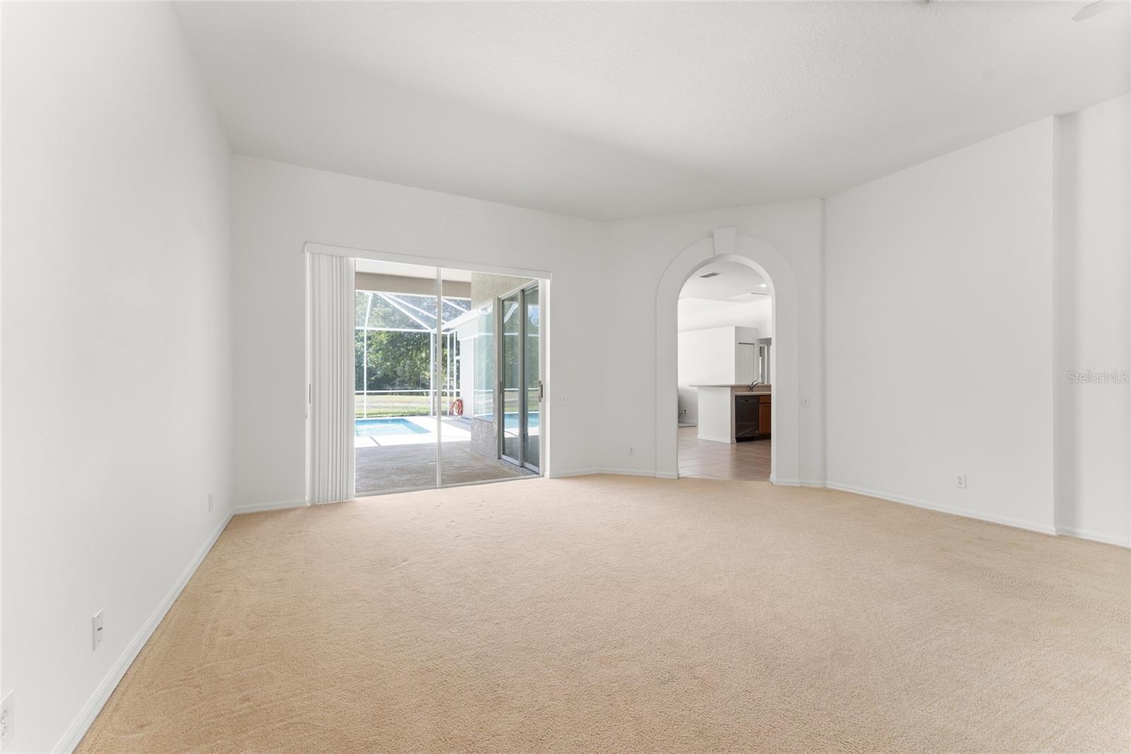 Formal Living Room With Views to the Pool & Kitchen