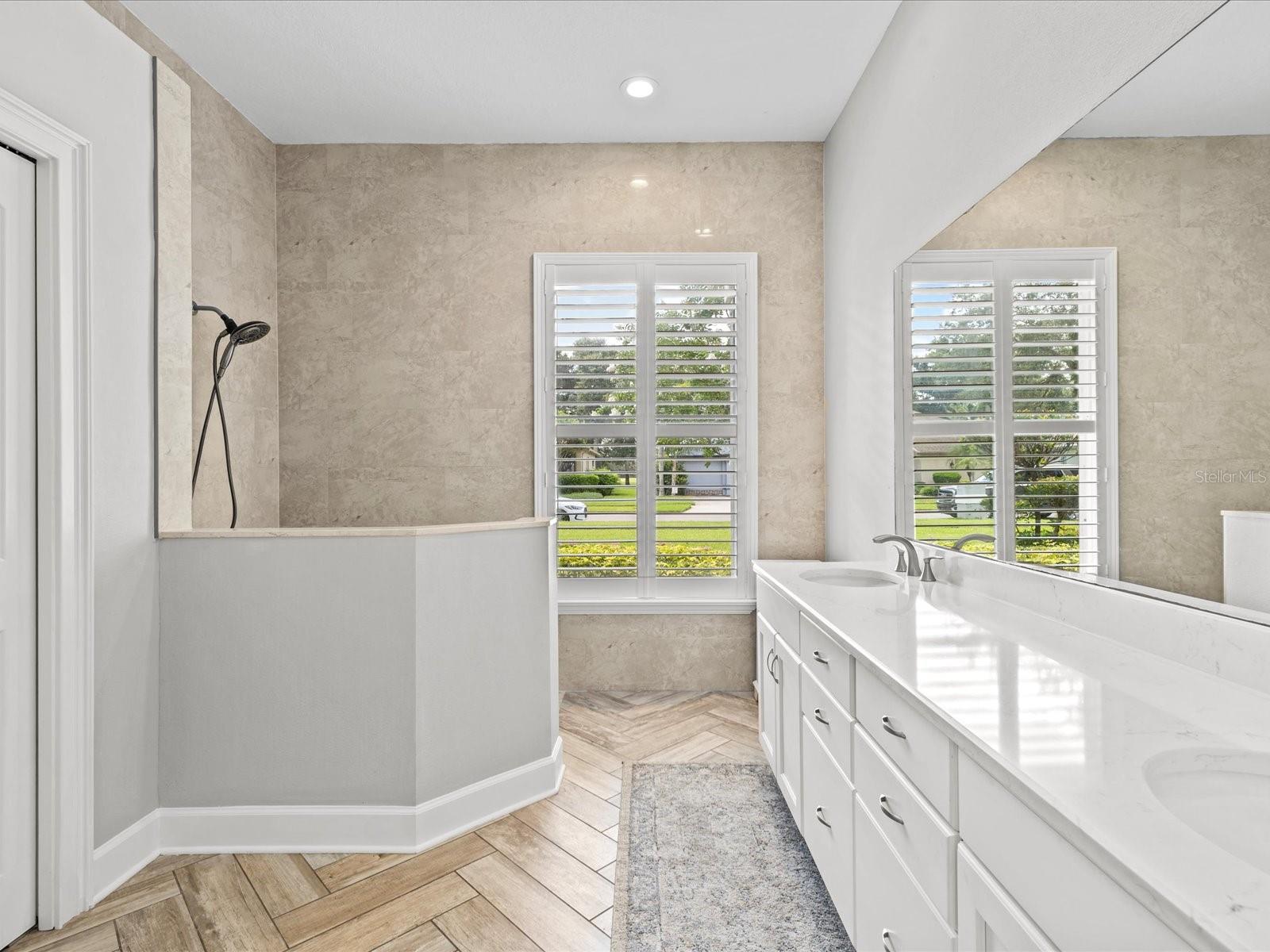 Updated Primary Bath with Dual Granite Vanity, Walk In Shower and Private Water Closet