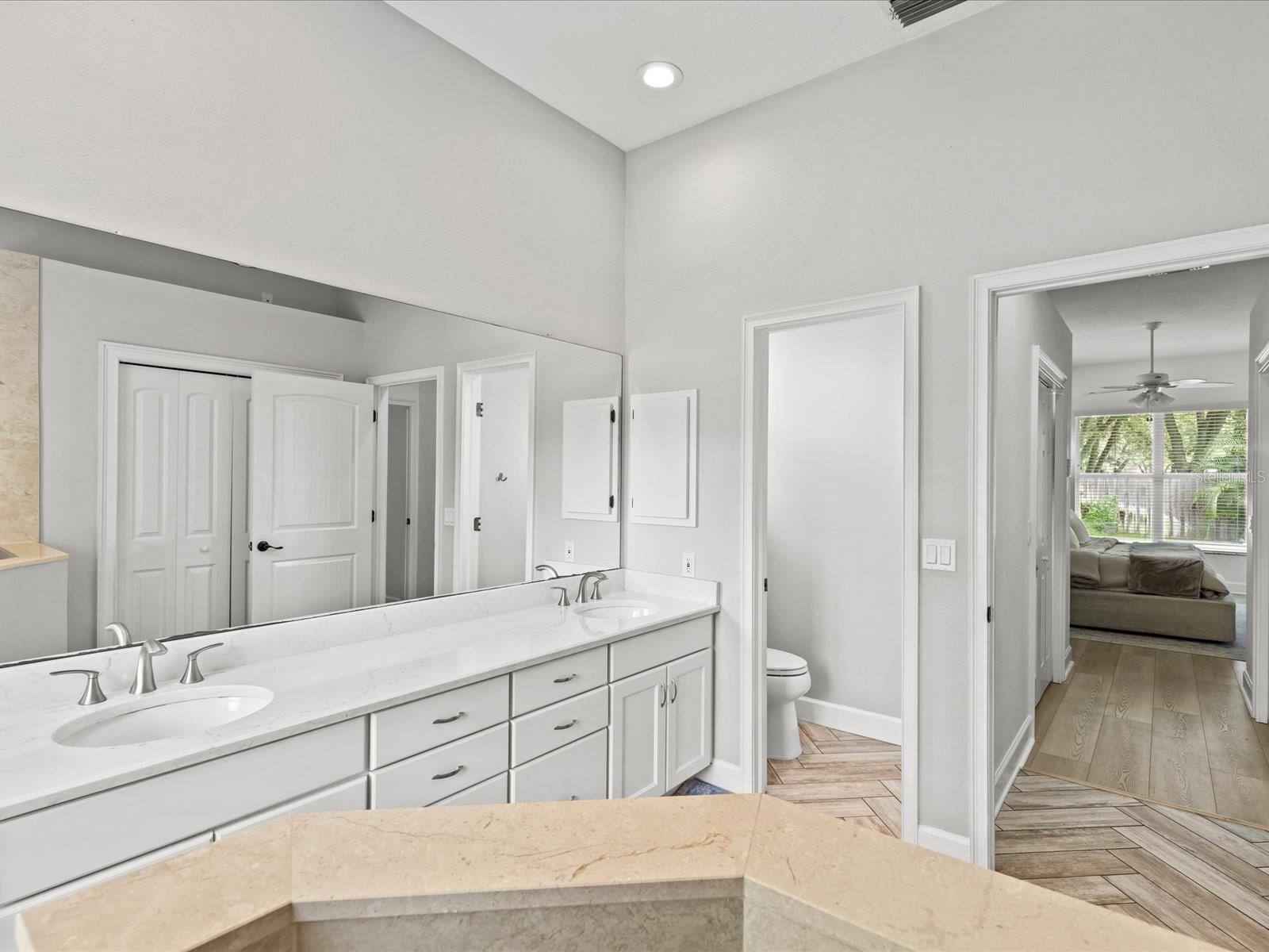 Updated Primary Bath with Dual Granite Vanity, Walk In Shower and Private Water Closet