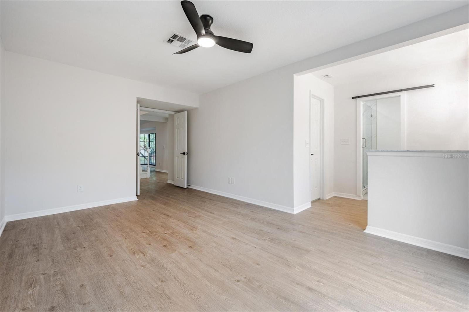 View inside primary bedroom with walk-in closet before the bathroom