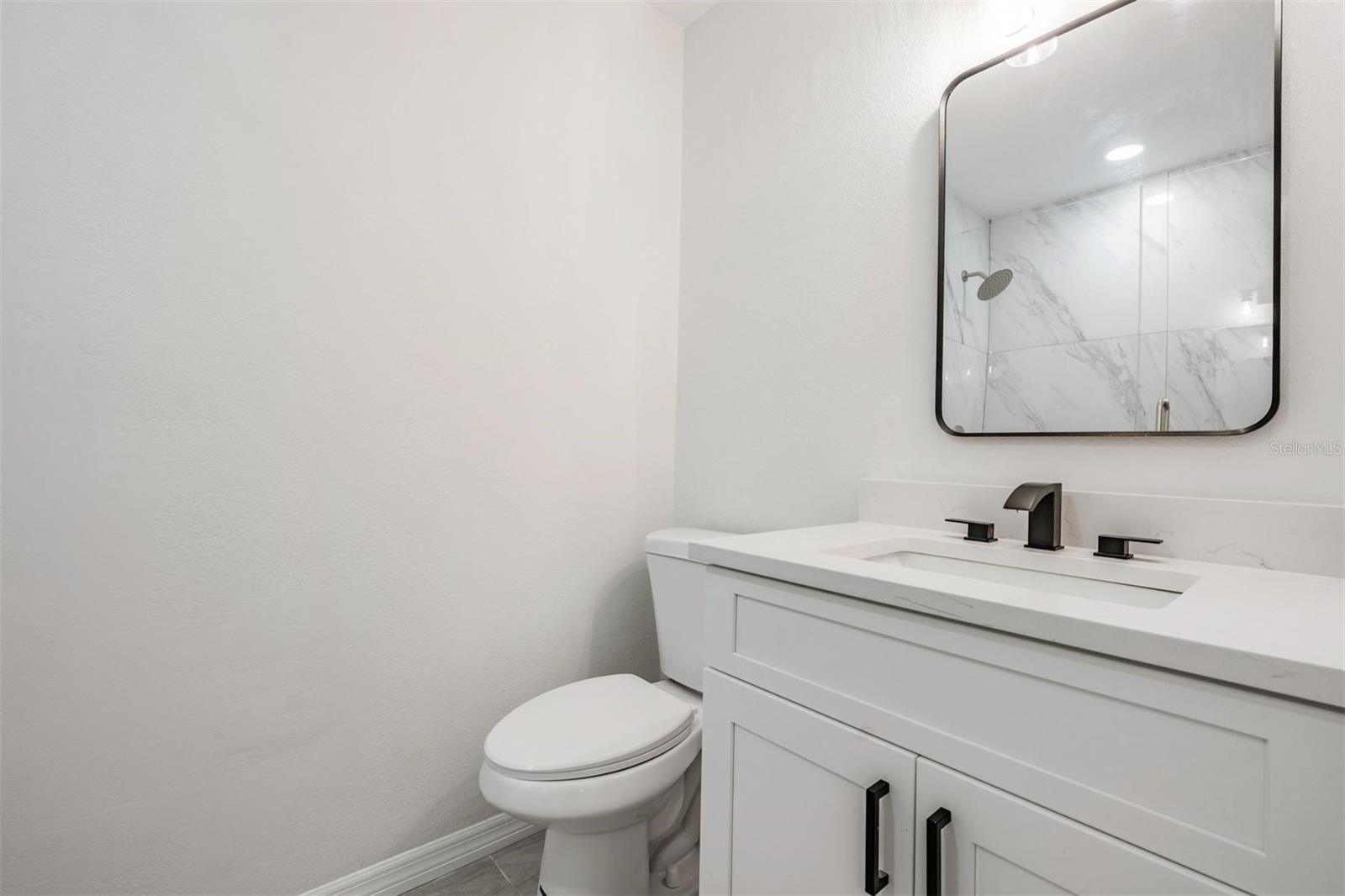 Other primary bedroom vanity beyond the barn door