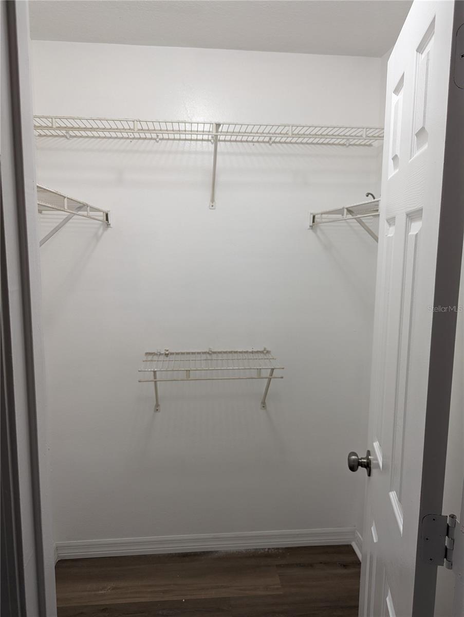 Primary bedroom walk in closet