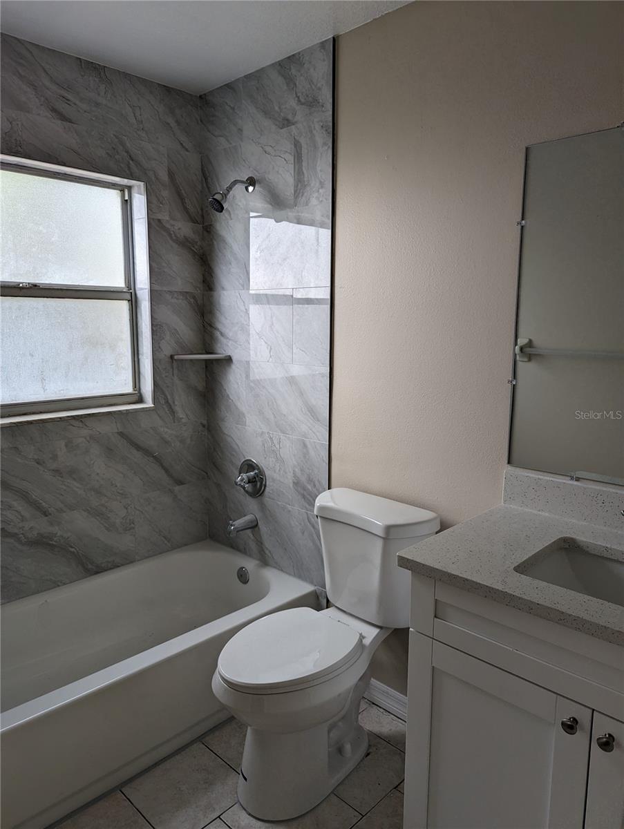 Primary bathroom with quartz countertop.