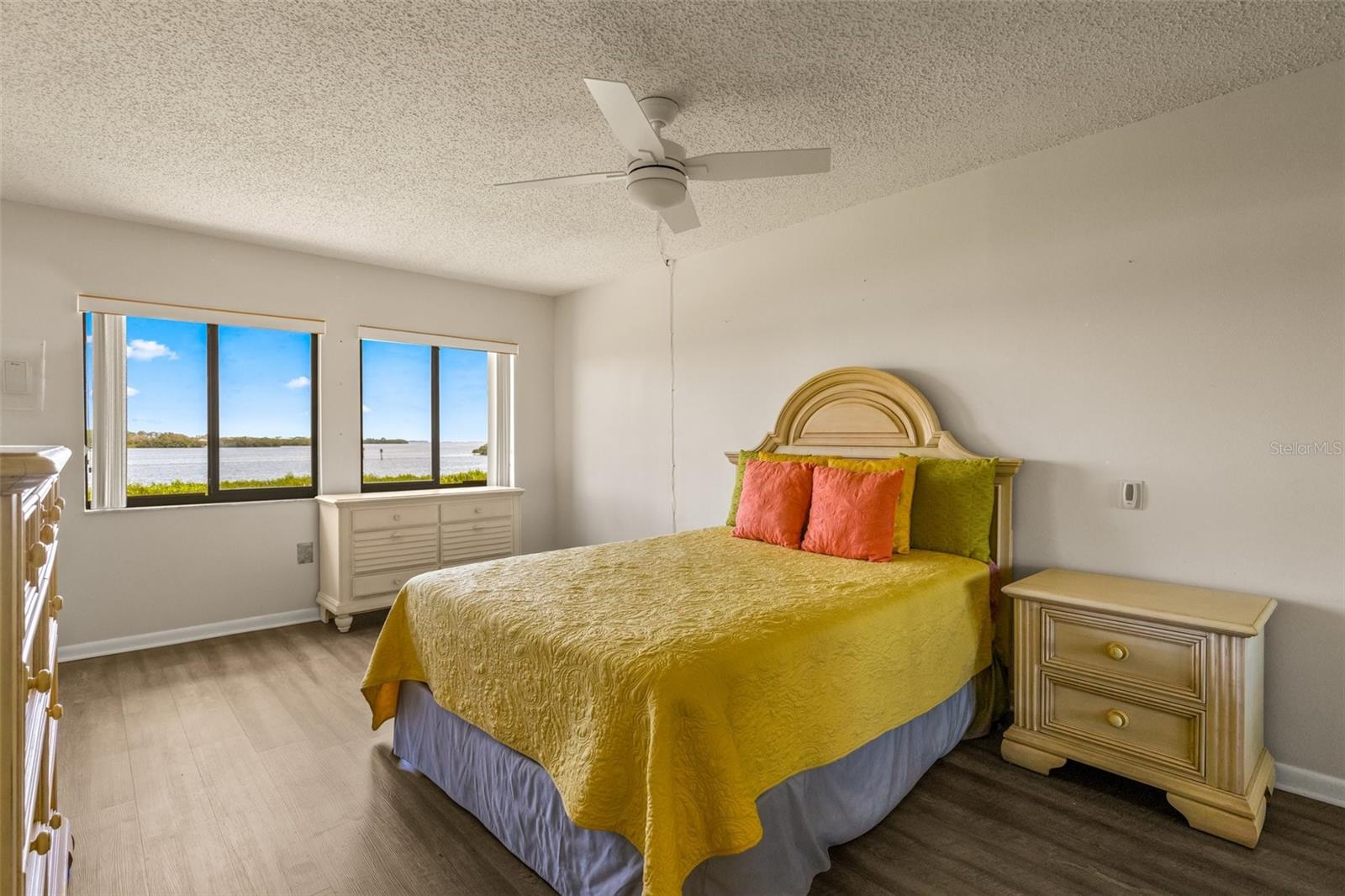 Primary Bedroom with a fantastic water view, access to screened porch