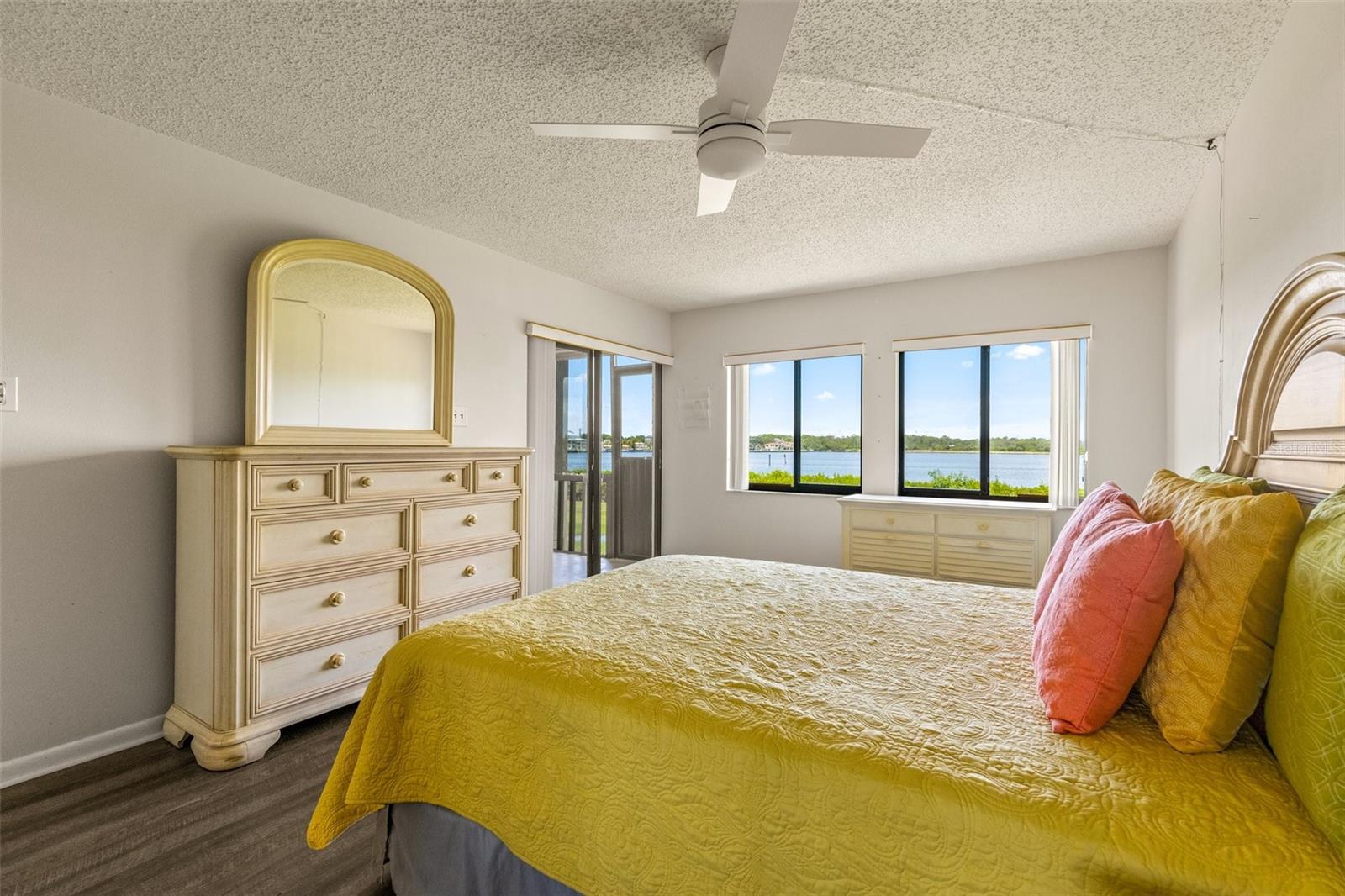 Primary Bedroom with a fantastic water view, access to screened porch