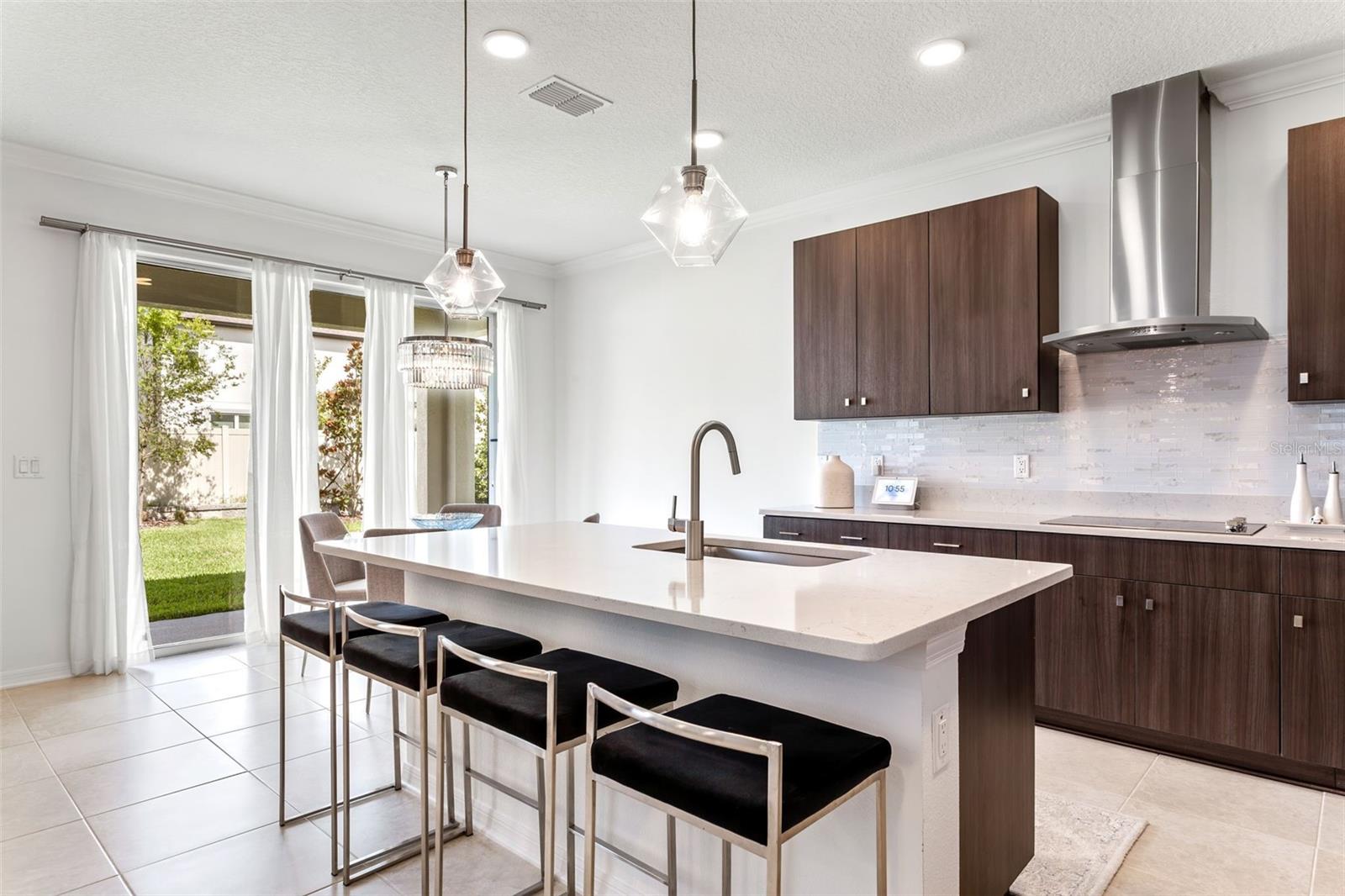 Quartz countertops, upgraded kitchen with pendant lighting and searing at the island.