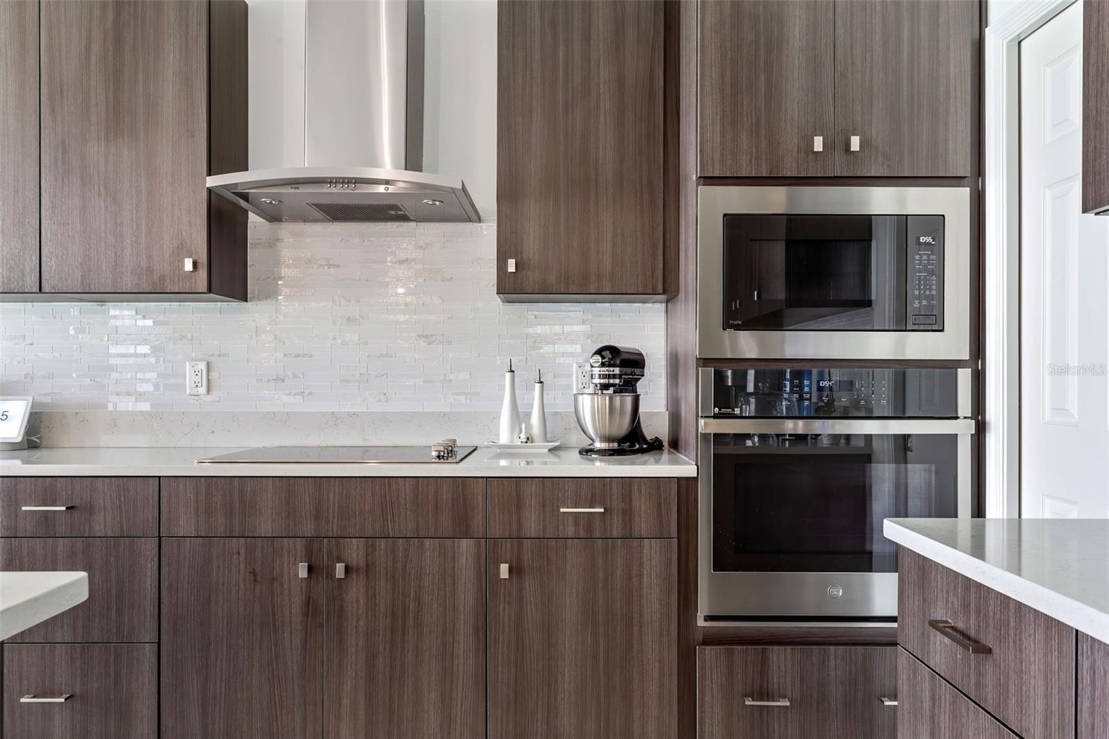 Oven and microwave in-wall provide extra space & sit next to the closet pantry.