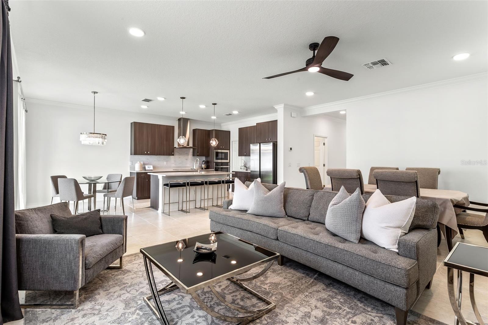 The living room features an open floorplan with direct access to the kitchen and dining areas.