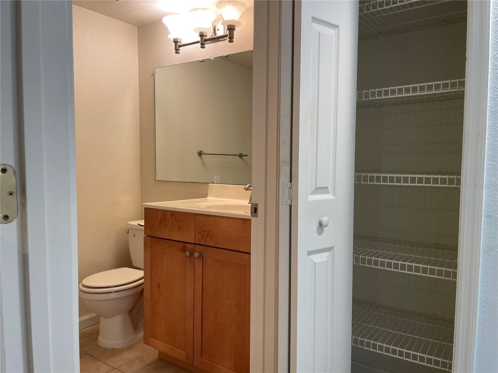 Ensuite bath and linen closet in primary bed