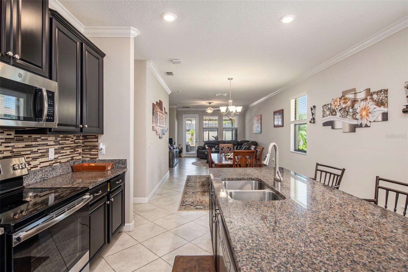 Spacious kitchen with a central island. Granite countertops, double backsplash, and tons of storage space!