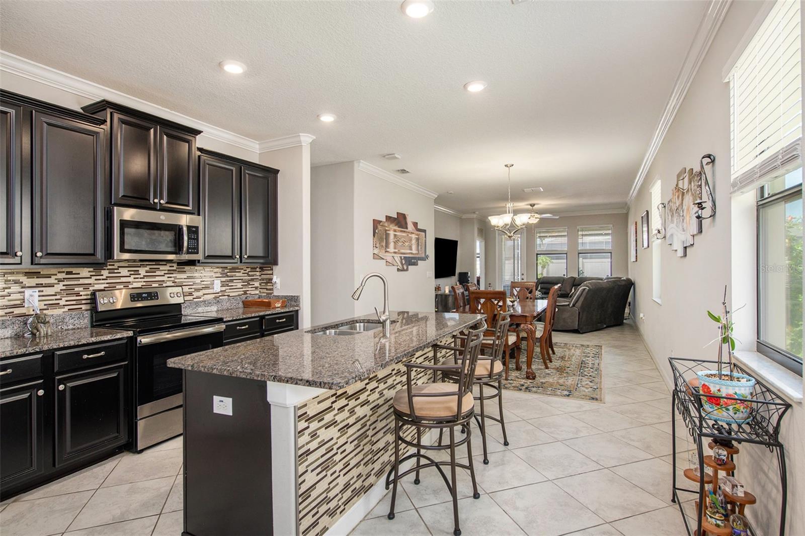 Spacious kitchen with a central island. Granite countertops, double backsplash, and tons of storage space!