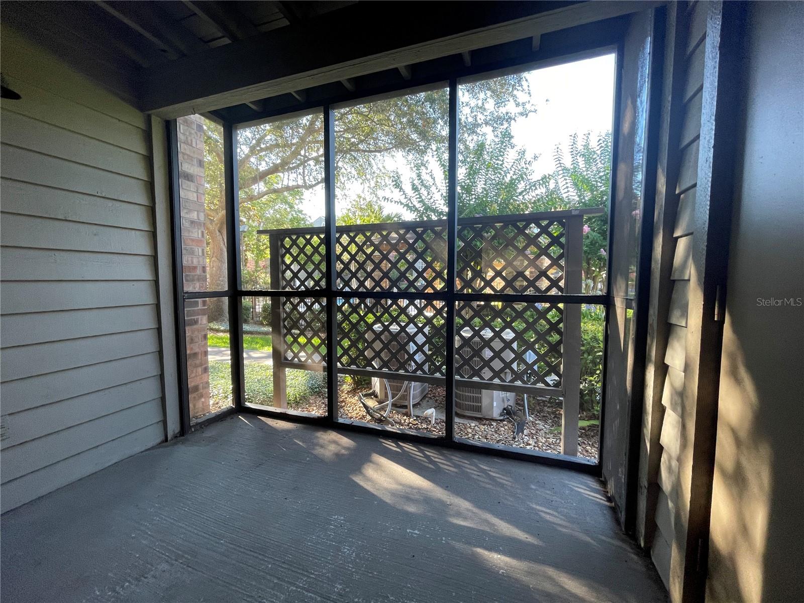 Screened rear porch with garden view