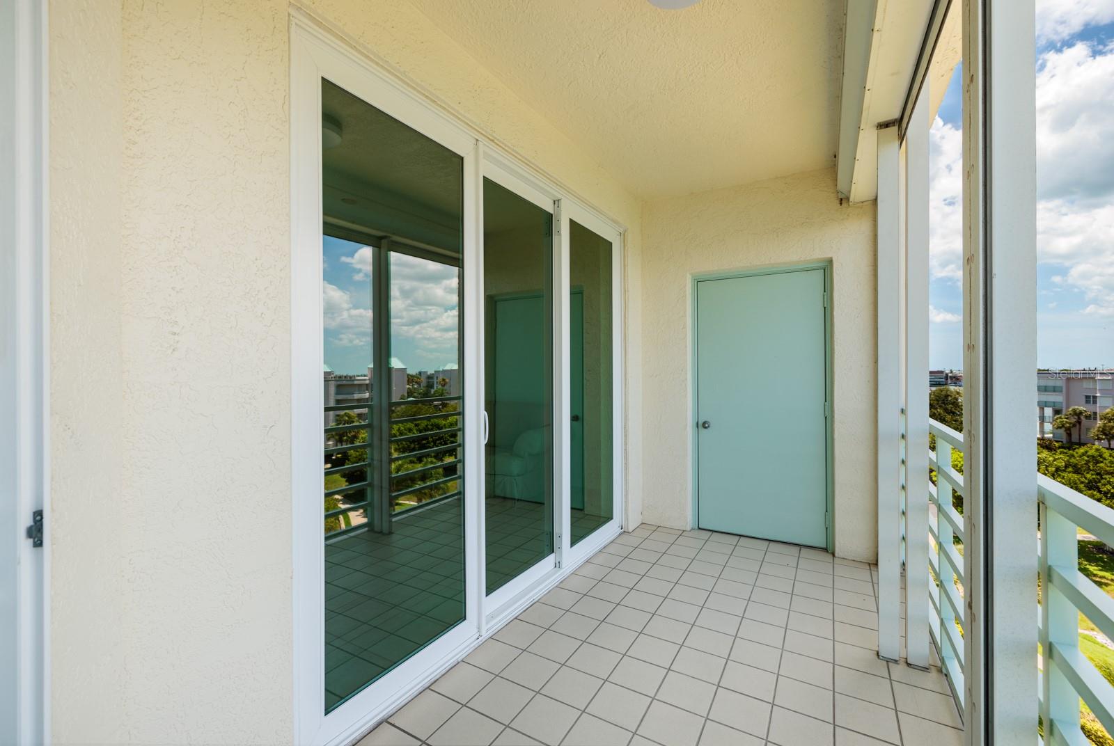 Balcony with storm shutter and hurricane resistant sliders.