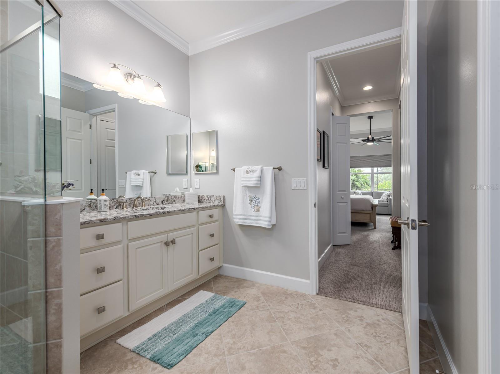 Primary ensuite bathroom with dual vanities