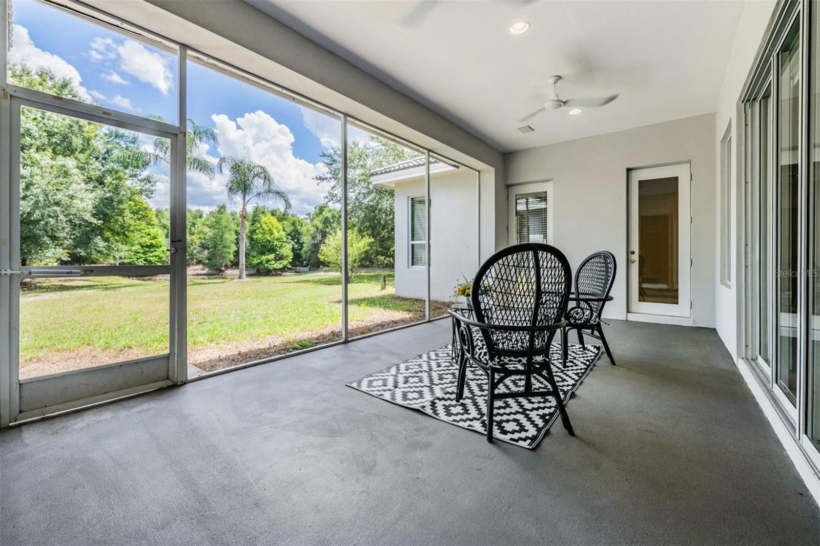 Covered and screened back patio - conservation lot.