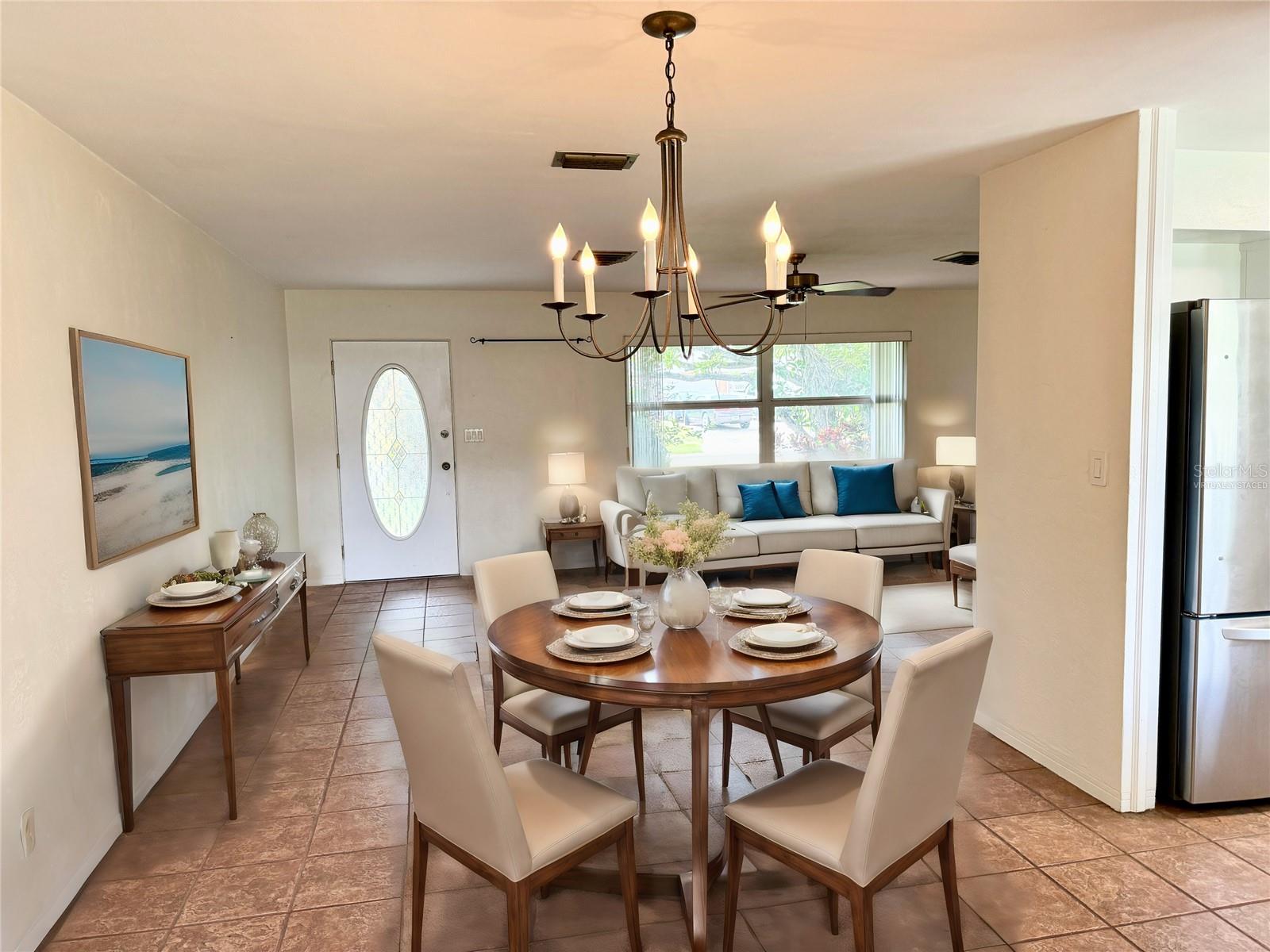 Virtually staged dining room looking into the living room