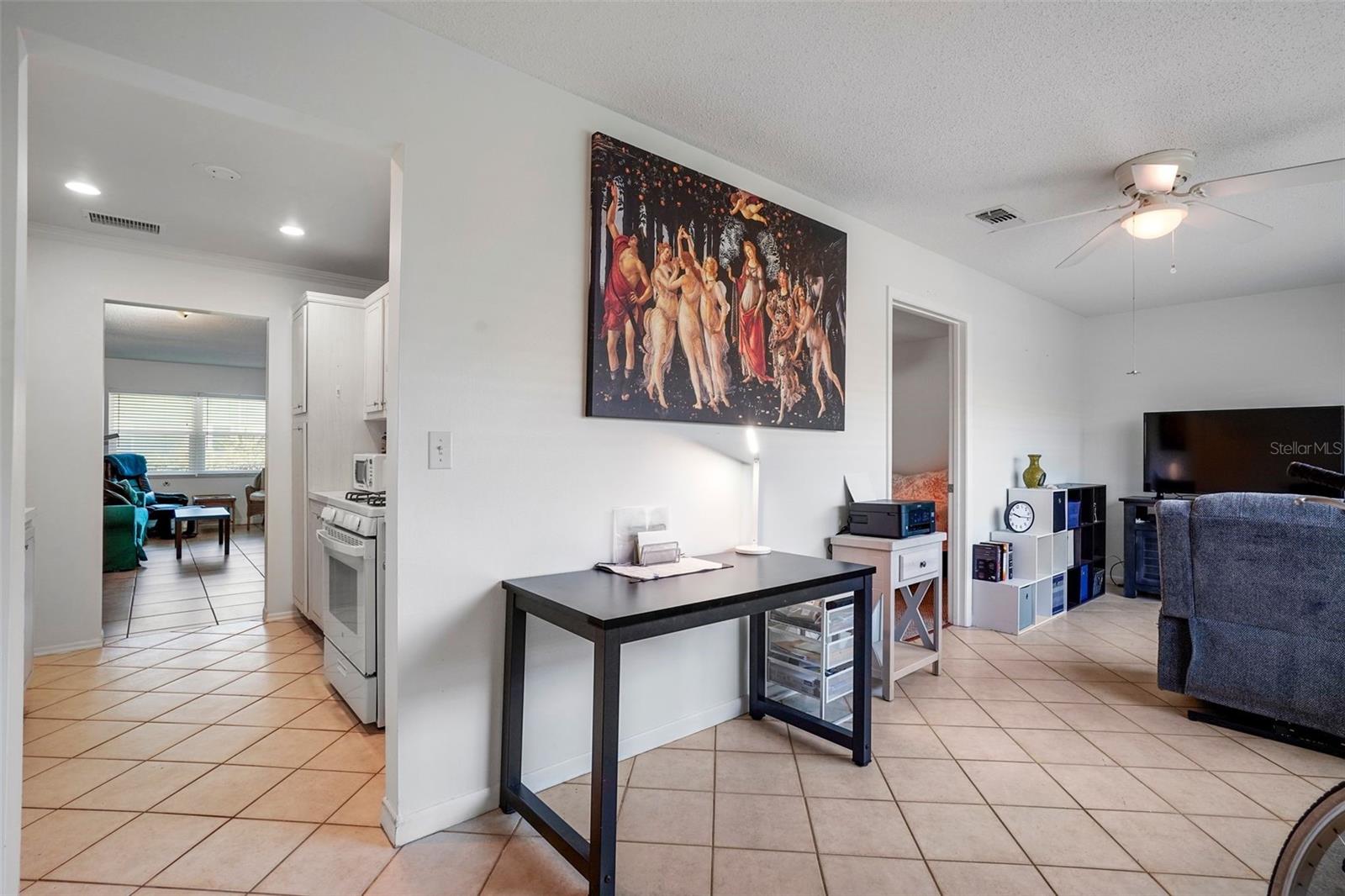 Sitting room off the back of the condo with access to kitchen and primary bedroom