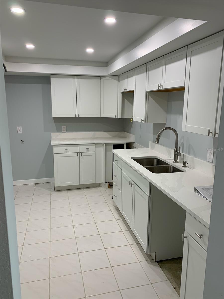 Kitchen facing fridge area with custom ceiling