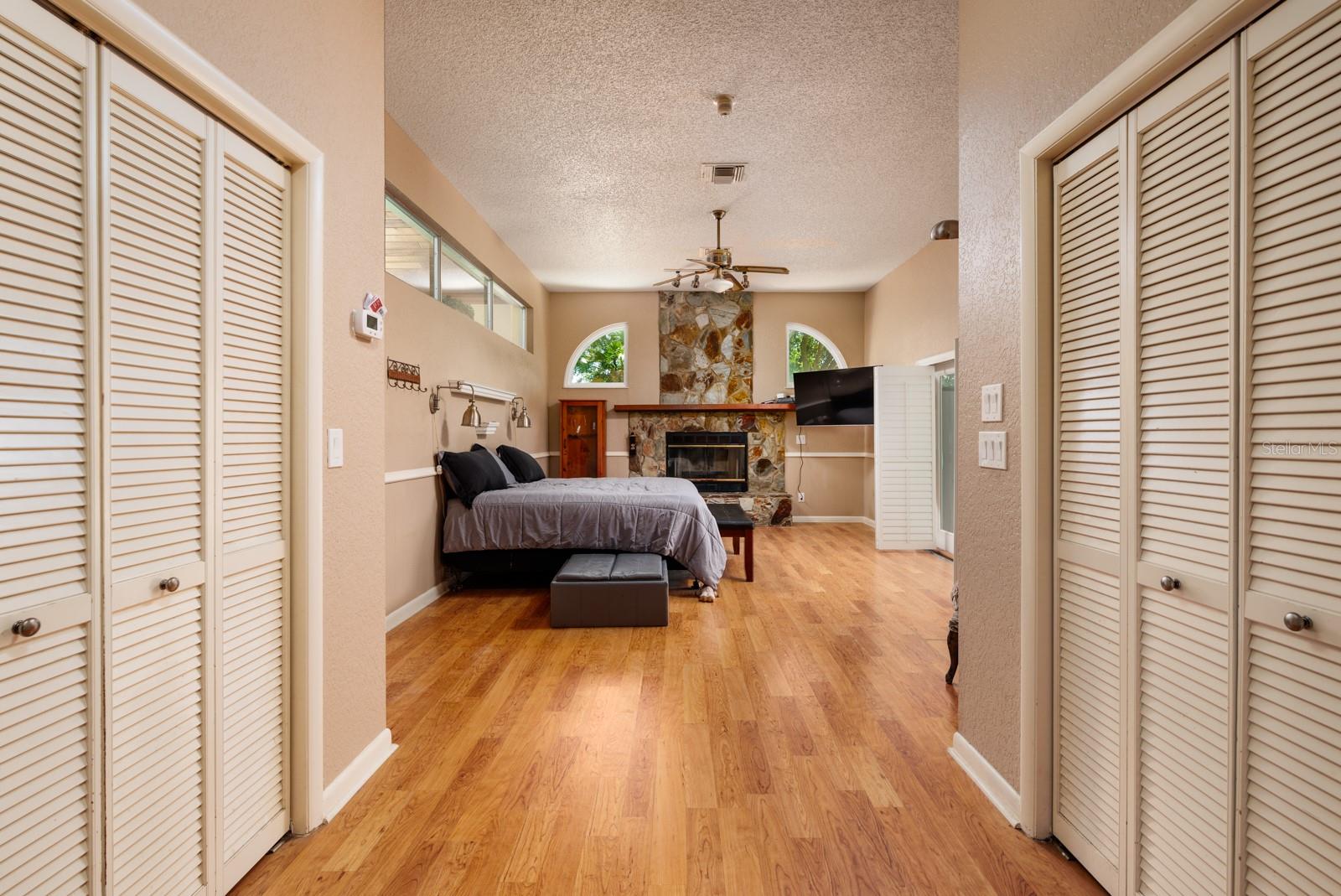 Primary Bedroom featuring fireplace and double closets.