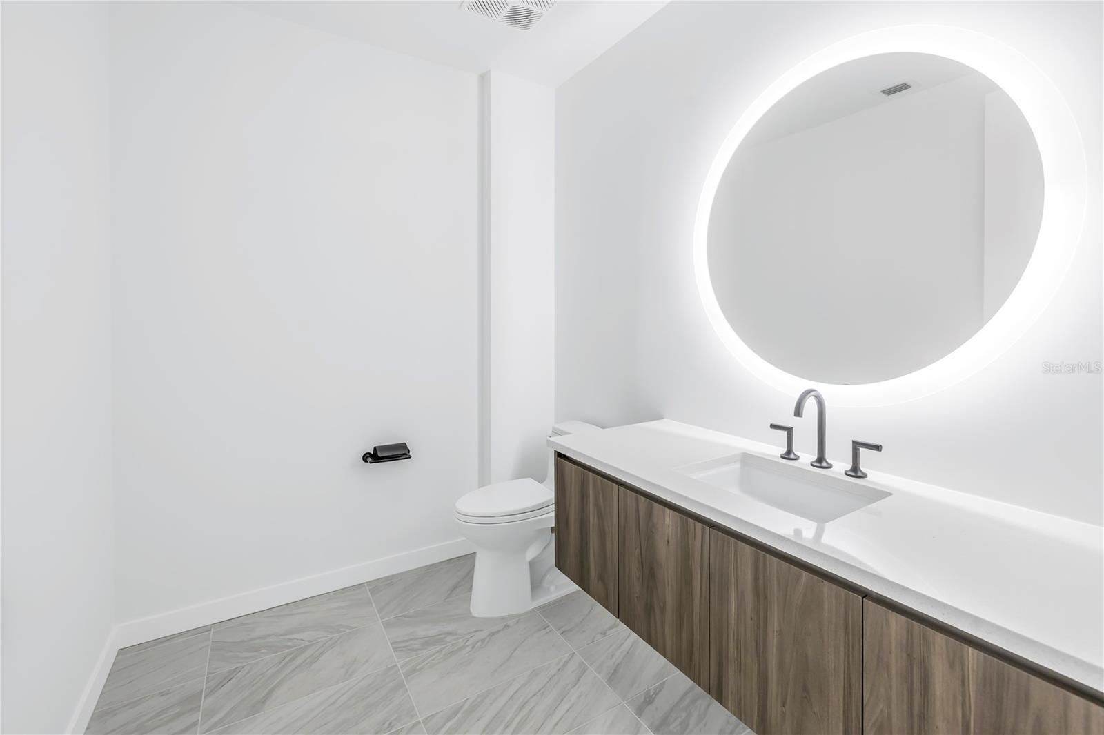 Half bath with backlit mirror