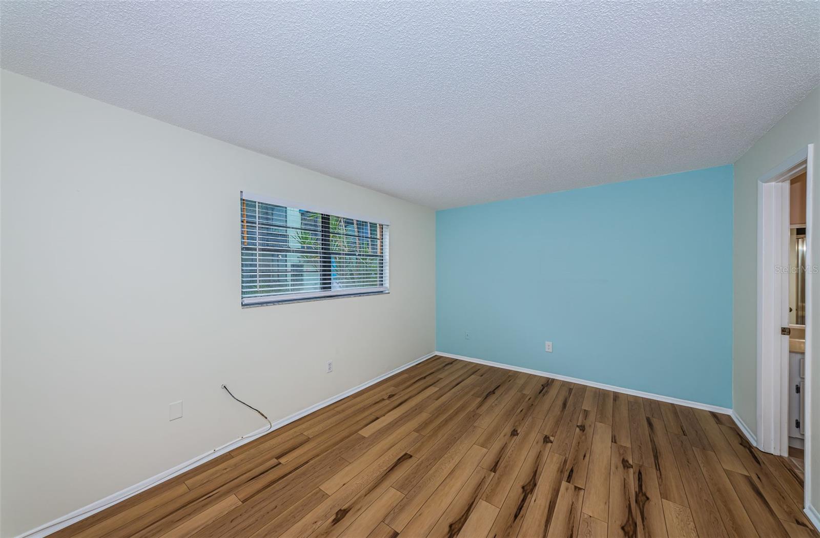 Master bedroom has luxury vinyl plank floors and ensuite bath