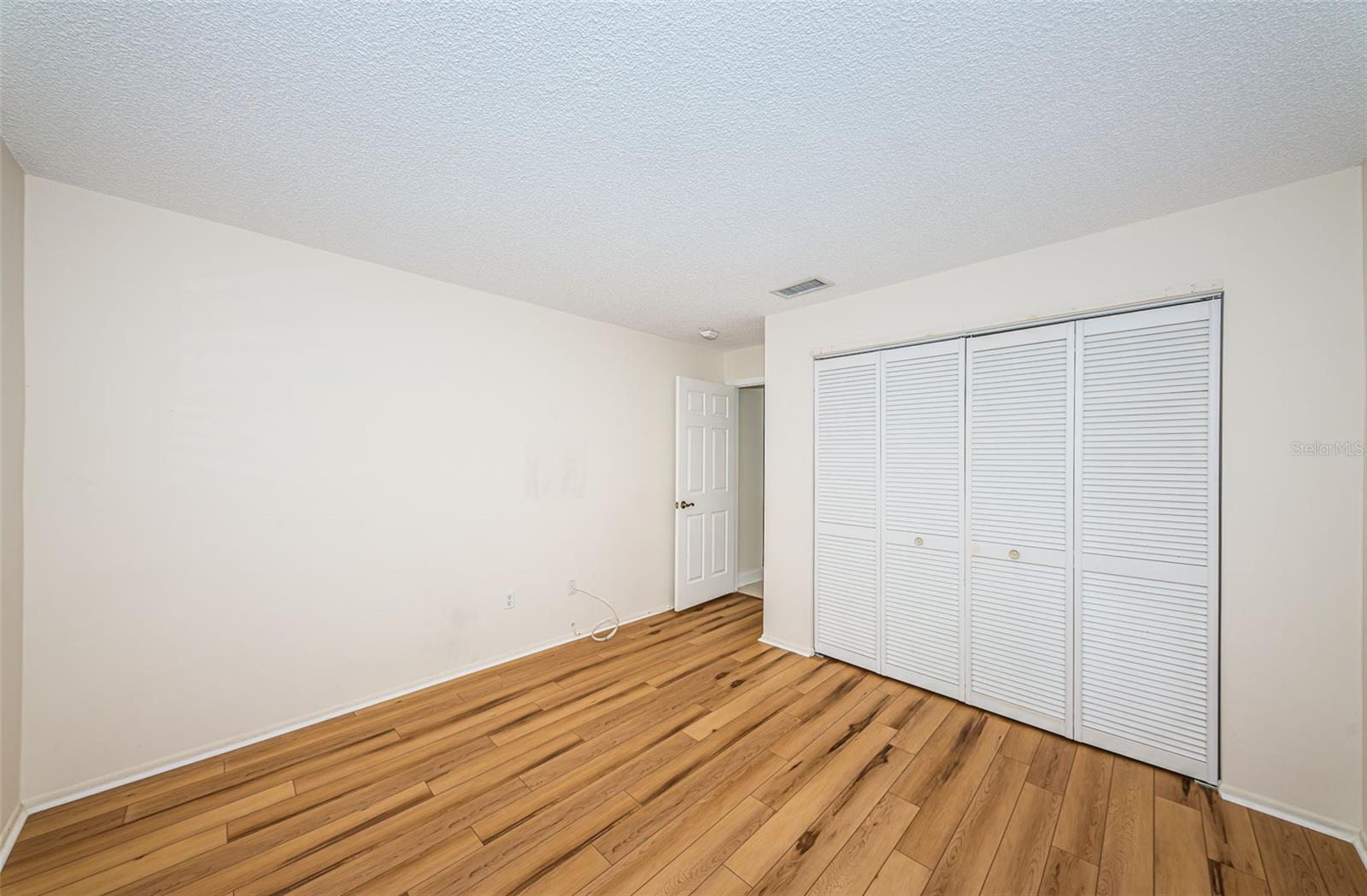 Guest bedroom with luxury vinyl plank flooring