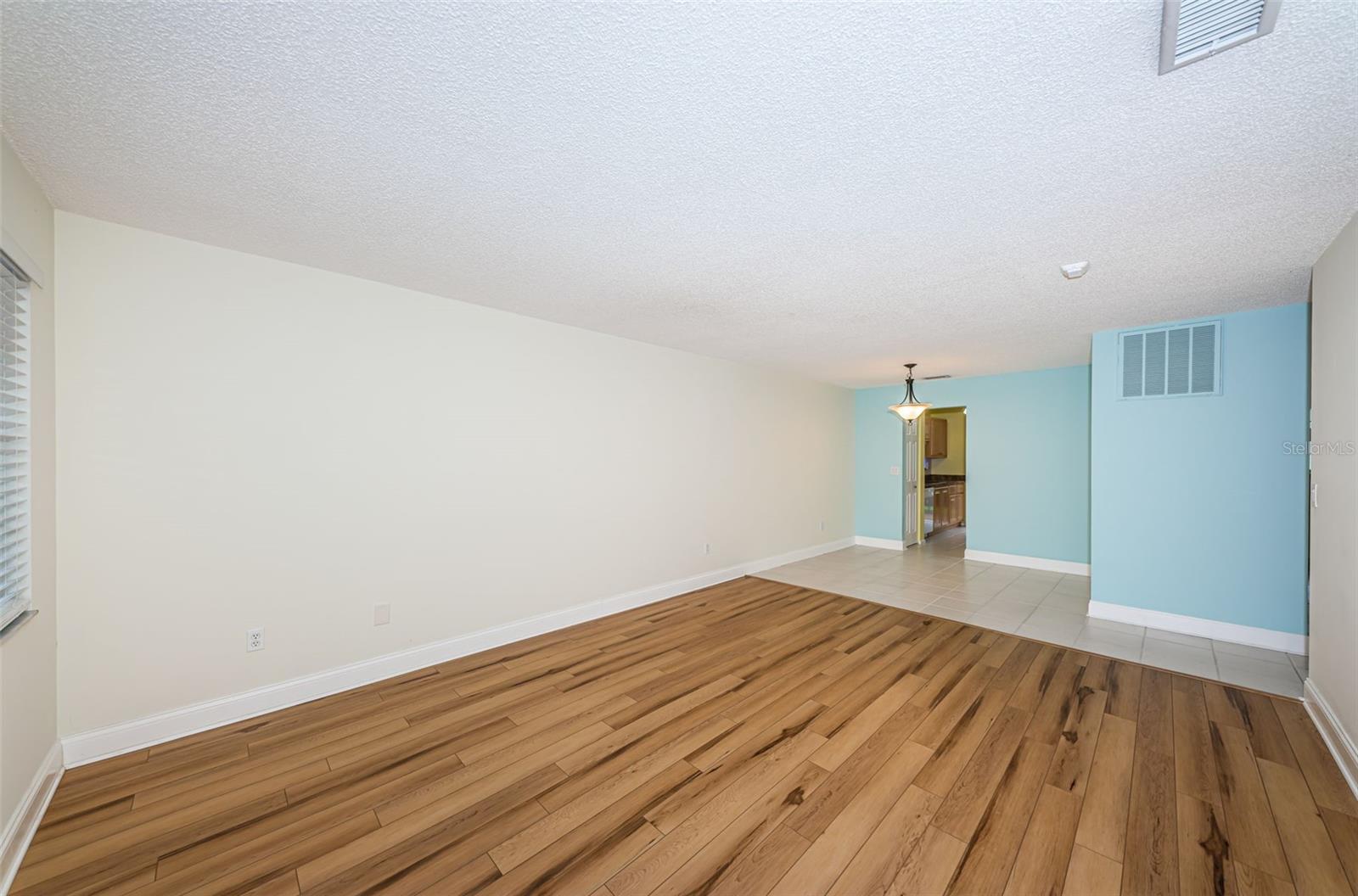 Living room looking into dining area and kitchen